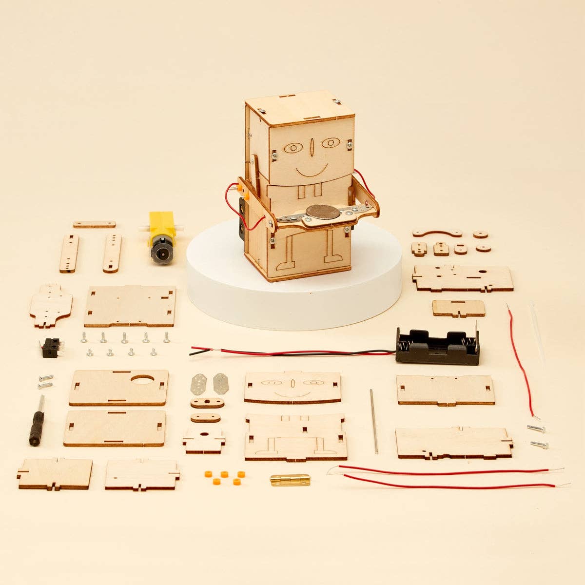 Wooden robot kit with components on a beige background