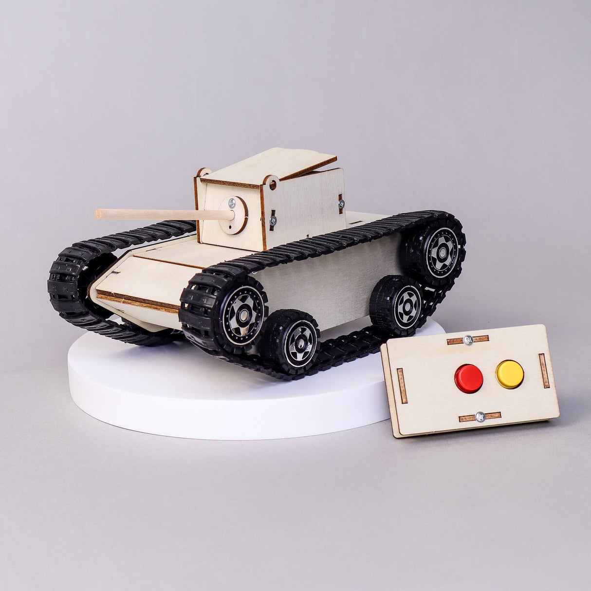 Wooden toy tank model with control panel on a gray background