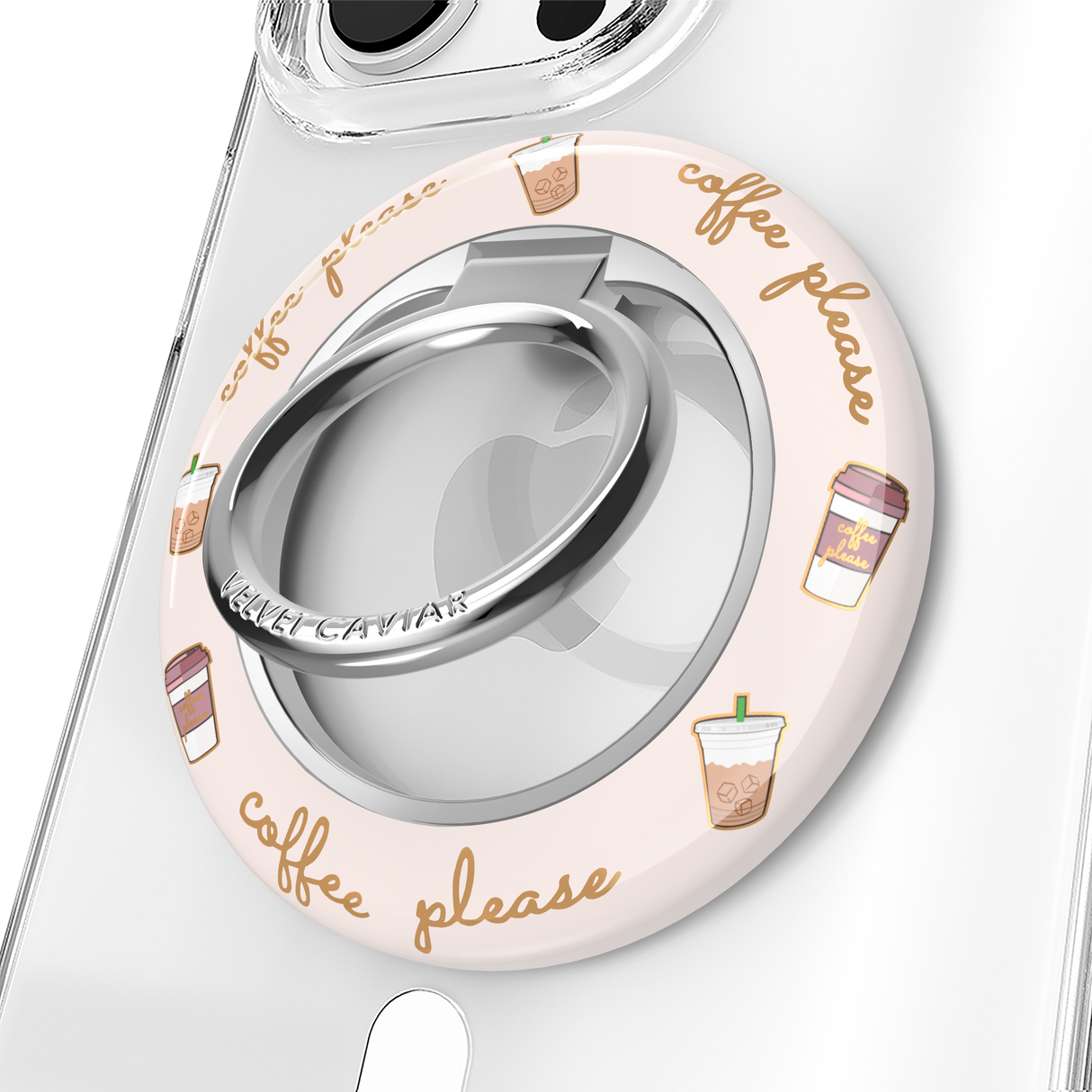 A clear phone case with a circular light pink protective bumper featuring 'coffee please' script and iced coffee illustrations. The bumper includes a silver metallic ring stand in the center.