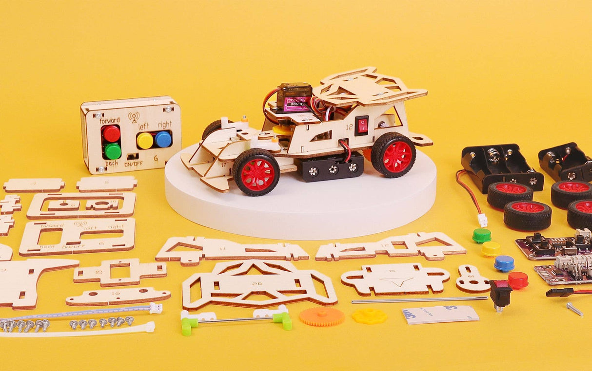 Mechanical model kit with assembled vehicle and unassembled parts on a yellow background