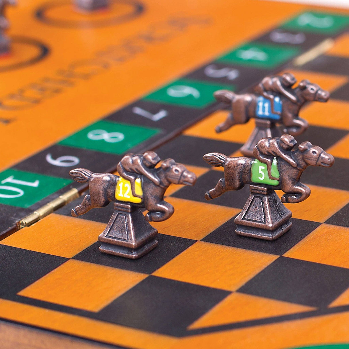Metal horse figurines on a checkered board with numbers
