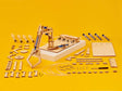 Wooden mechanical arm model kit with components on a yellow background