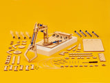 Wooden mechanical arm model kit with components on a yellow background