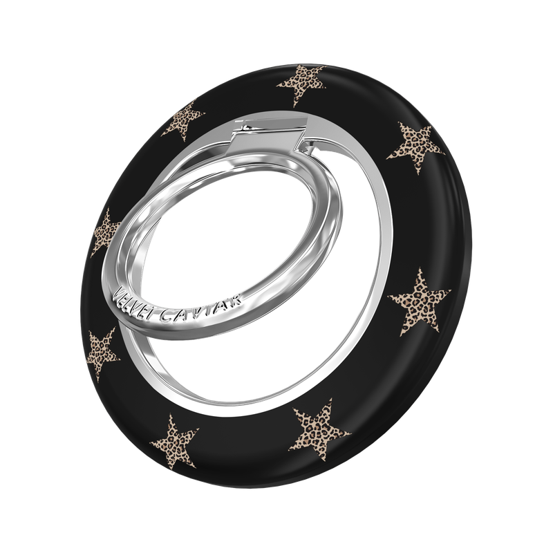 A black ring holder with a silver metal core and gold star accents, featuring the brand name 'VELVET CAVIAR' engraved on the silver band, set against a plain white background.