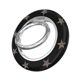 A black ring holder with a silver metal core and gold star accents, featuring the brand name 'VELVET CAVIAR' engraved on the silver band, set against a plain white background.