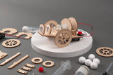 Wooden toy car model kit with components on a gray background
