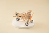 Wooden toy airplane on a white base with a beige background