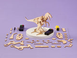 Wooden dinosaur model kit with components and tools on a purple background