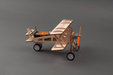 Wooden model airplane with orange propeller on a gray background
