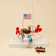 Model of a boat made from plastic bottles with motors and an American flag on a beige background
