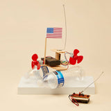 Model of a boat made from plastic bottles with motors and an American flag on a beige background
