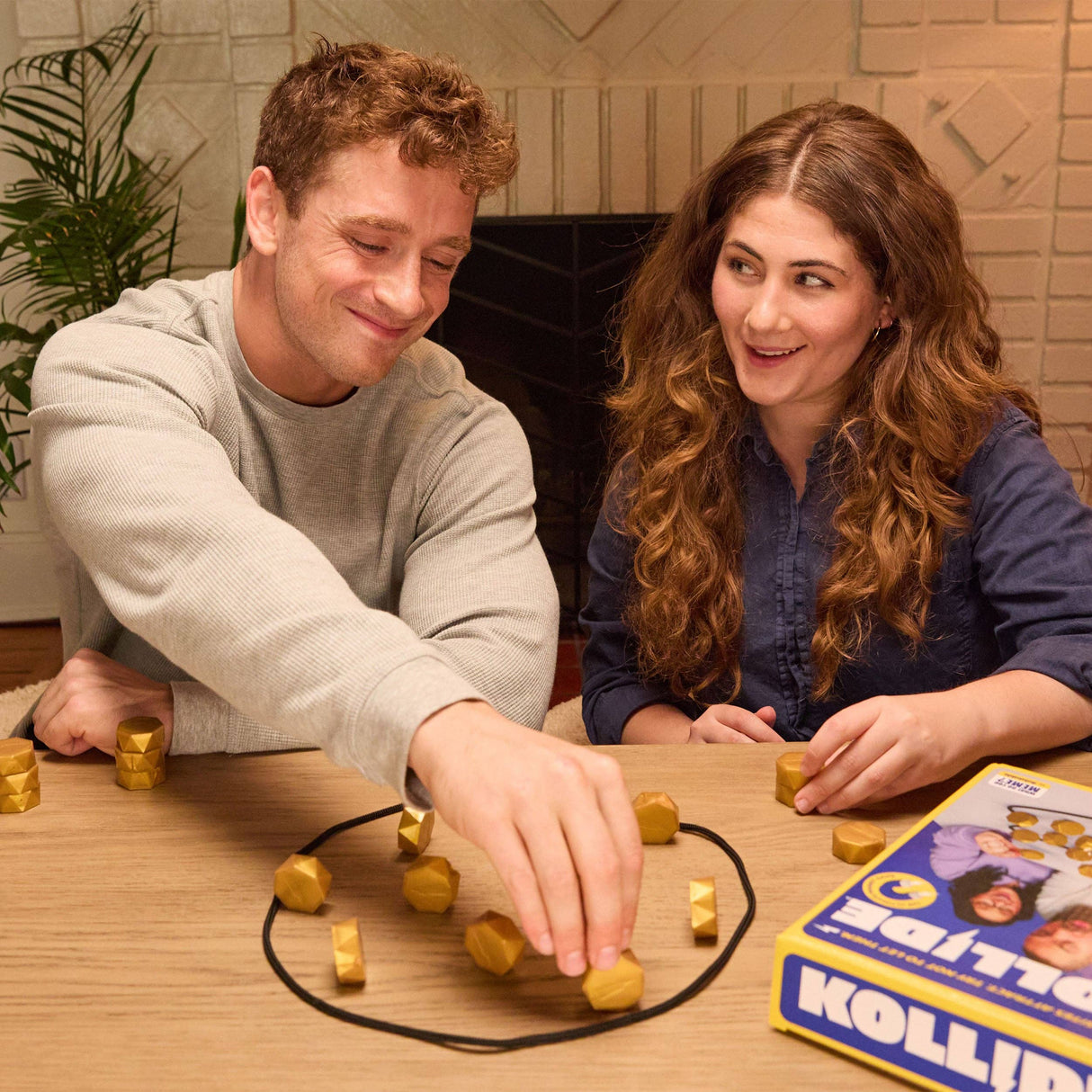 Two people playing a board game together at a table.