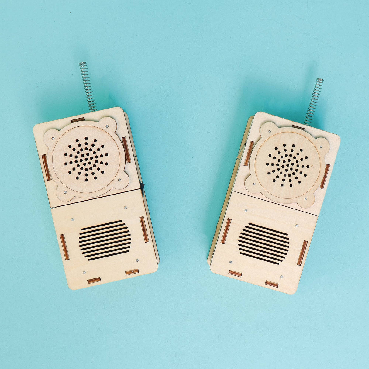 Two wooden walkie-talkies on a blue background