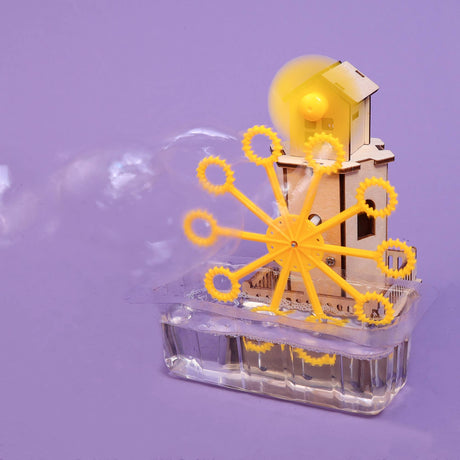 Mechanical model with yellow gears and transparent base on a purple background
