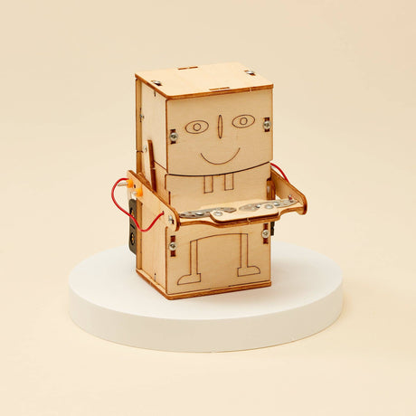 Wooden robot model on a white pedestal with a beige background