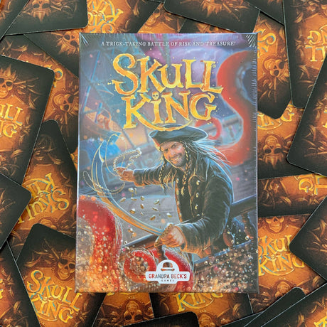 Skull King game box surrounded by game cards with skull and crossbones design.