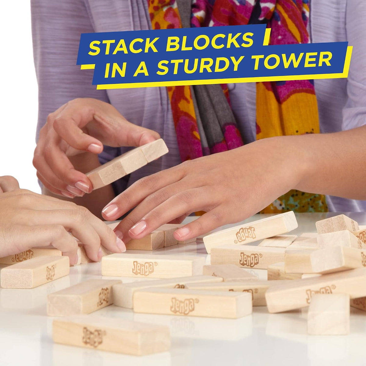 Friends playing Jenga and stacking hardwood blocks in a sturdy tower