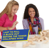 Players pulling the last block before the Jenga tower collapses