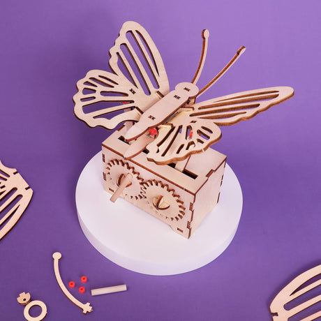 Wooden butterfly mechanical model on a purple background