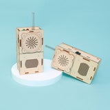 Two wooden mechanical devices resembling vintage radios on a light blue background