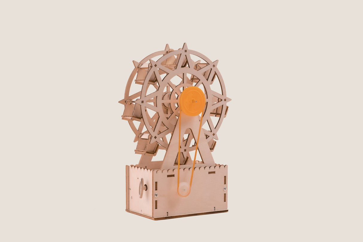 Wooden mechanical model of a Ferris wheel on a beige background