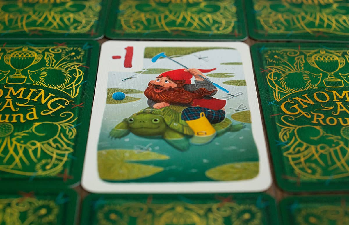 Card game with a gnome on a turtle illustration surrounded by green game boards.