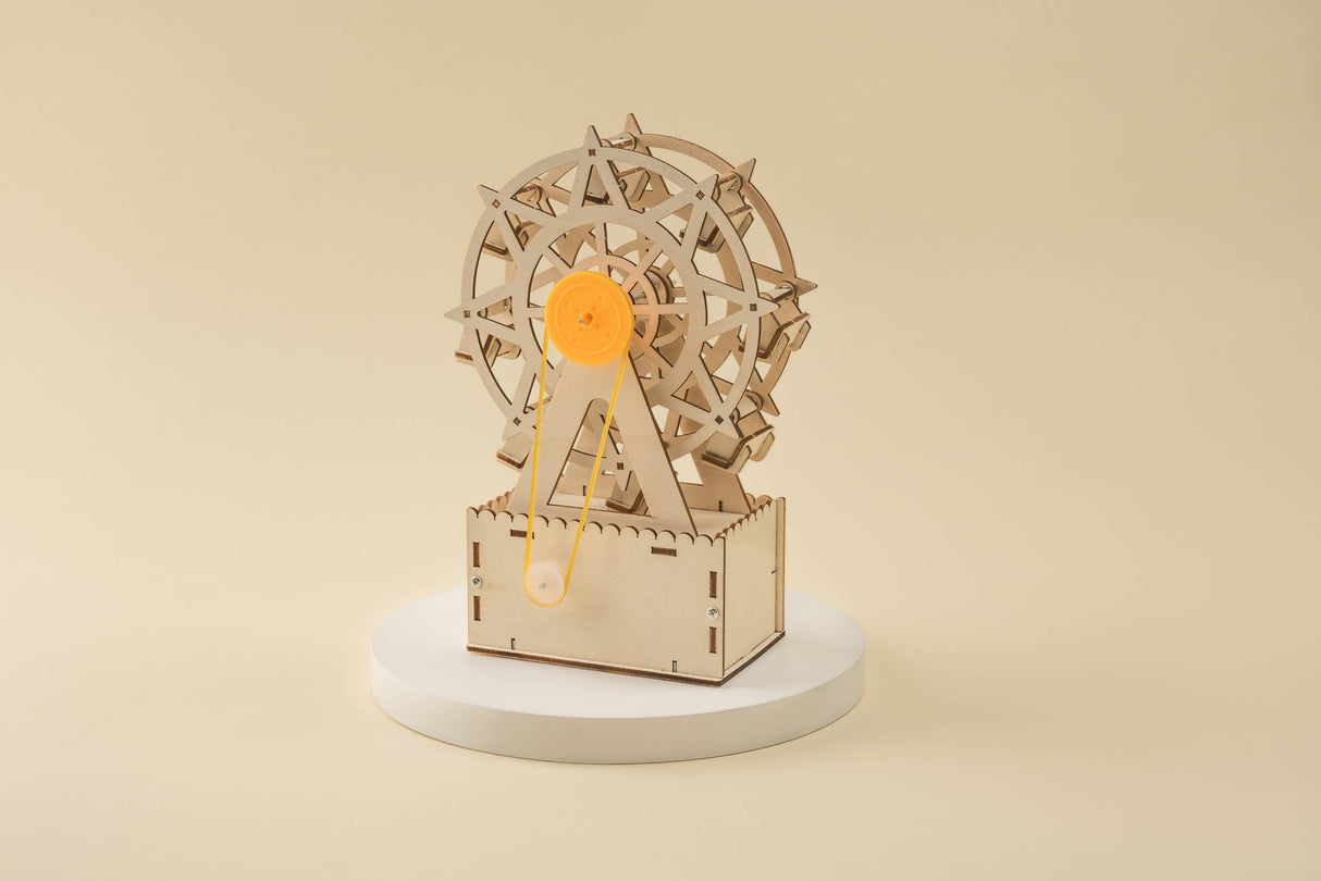 Wooden mechanical model of a Ferris wheel on a beige background