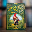 Board game box titled 'Gnoming a Round' with a gnome character on a blurred background