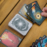 Playing cards with unique designs on a wooden surface