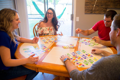 Adults playing SKYJO at a table