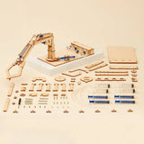 Wooden mechanical model kit with components on a beige background
