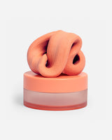 Speks Blur calming focus putty in orange on its container