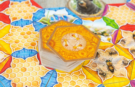Hexagonal tiles with bee designs on a colorful surface