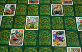 Collection of 'Gnoming Around' card game cards on a green patterned surface.