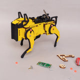 Yellow and black robot model with scattered parts on a light gray background