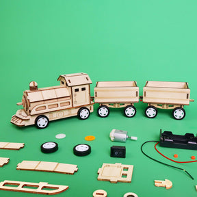 Wooden toy train set with components on a green background