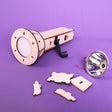 Wooden laser-cut components of a lamp on a purple background