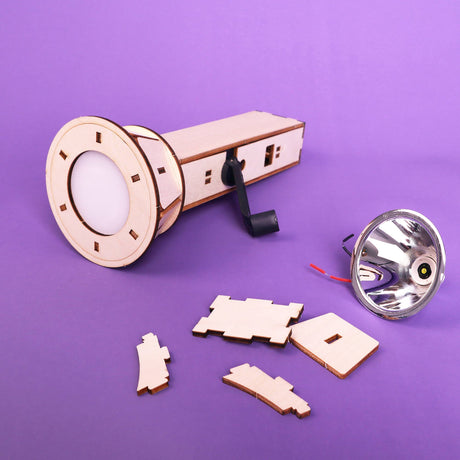 Wooden laser-cut components of a lamp on a purple background
