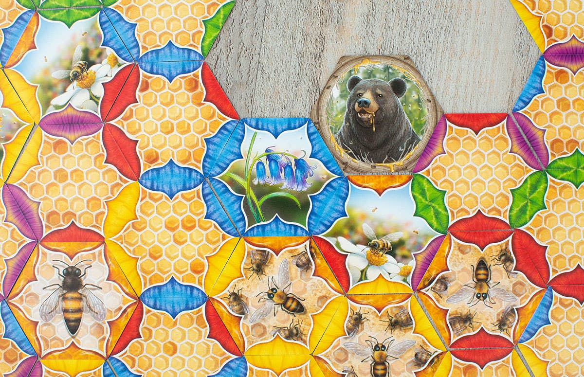Colorful mosaic pattern with bees, flowers, and a bear's face.