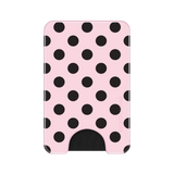 A slim pink wallet or card holder with a black polka dot pattern and a black cutout at the bottom, shown on a plain white background.