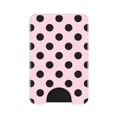 A slim pink wallet or card holder with a black polka dot pattern and a black cutout at the bottom, shown on a plain white background.
