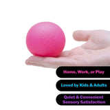 A pink stress ball resting on an open hand against a white background, with three black text banners at the bottom reading 'Home, Work, or Play', 'Loved by Kids & Adults', and 'Quiet & Convenient Sensory Satisfaction'.
